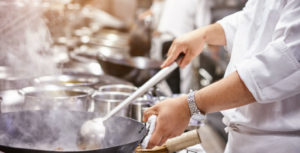 Chef in the kitchen - Hine Chartered Insurance Brokers